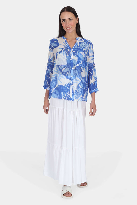 Woman wearing blue and white tropical print blouse